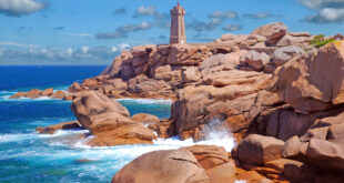 a lighthouse on a rocky beach